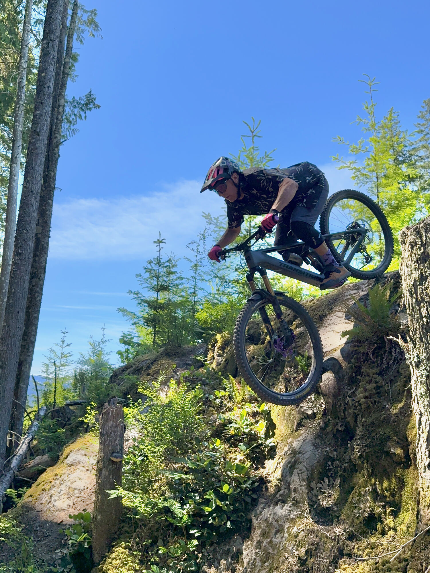 Mountain biker dropping into a technical rock line
